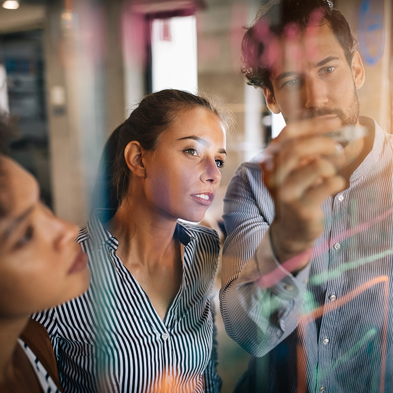 Diverse team working on ideas in office with pen