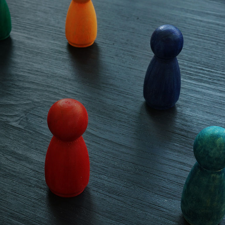 Diversity and inclusion for business concept. Colored figurines on the desk.