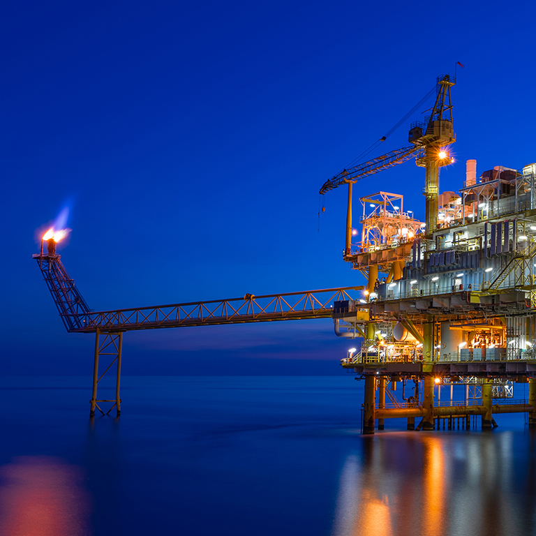 Offshore oil and gas central processing platform in sunset, petroleum business for worldwide energy.
