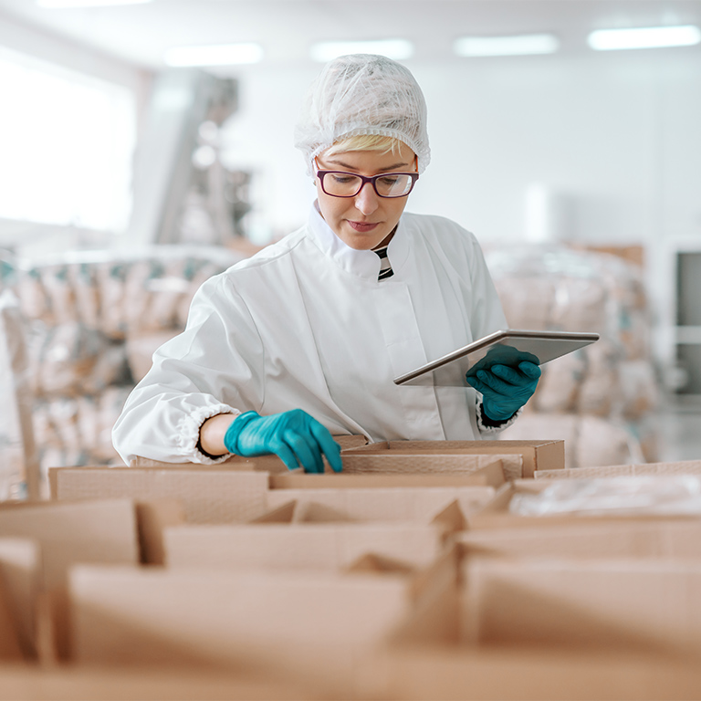 Employee packing in food factory