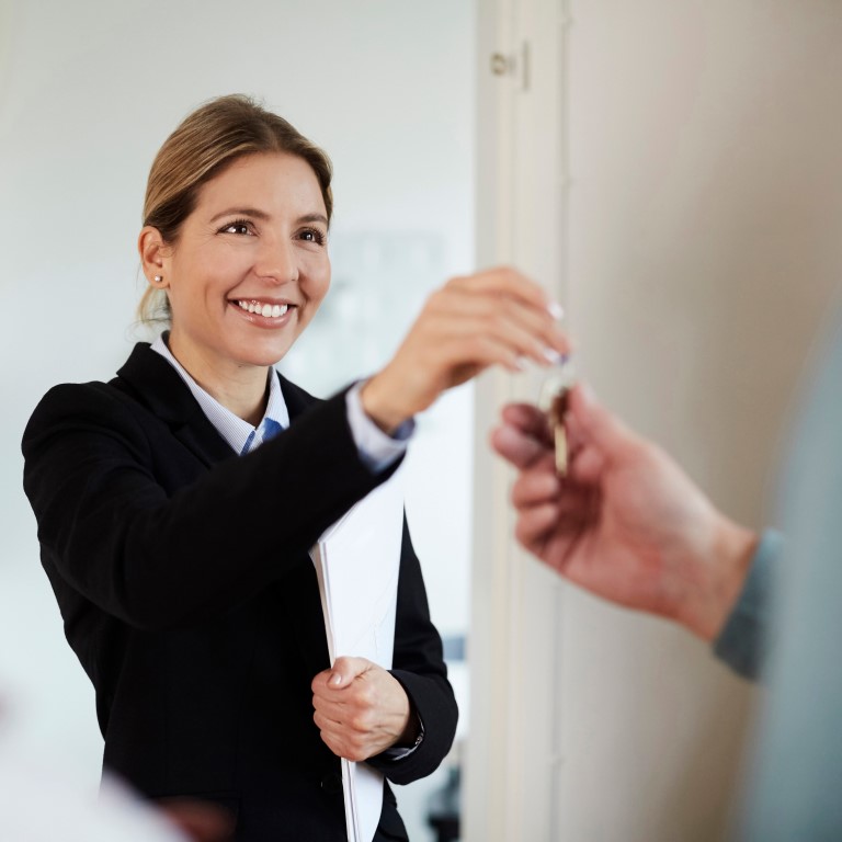 female landlord handing over property keys