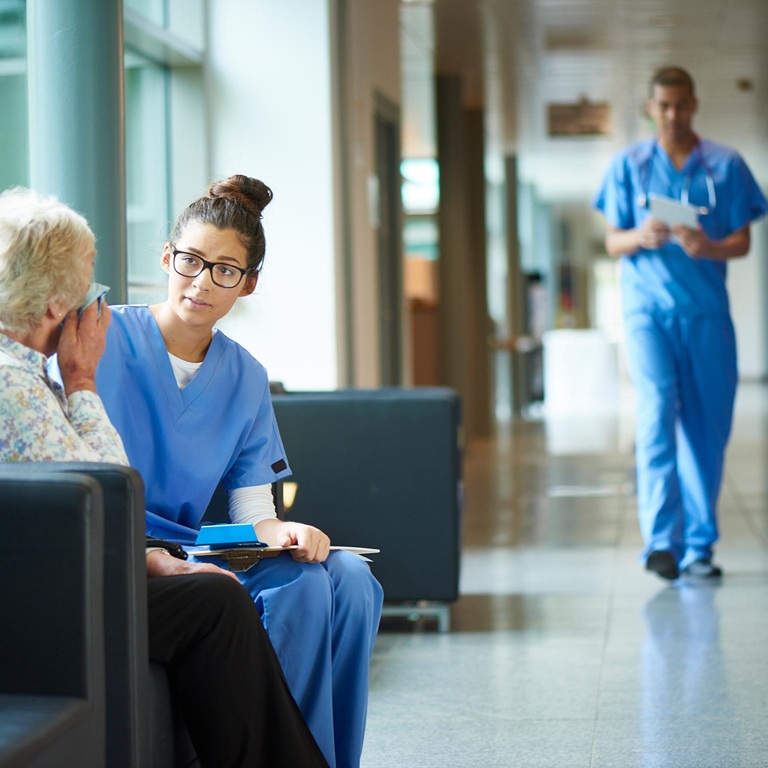 Female nurse consoles an upset patient