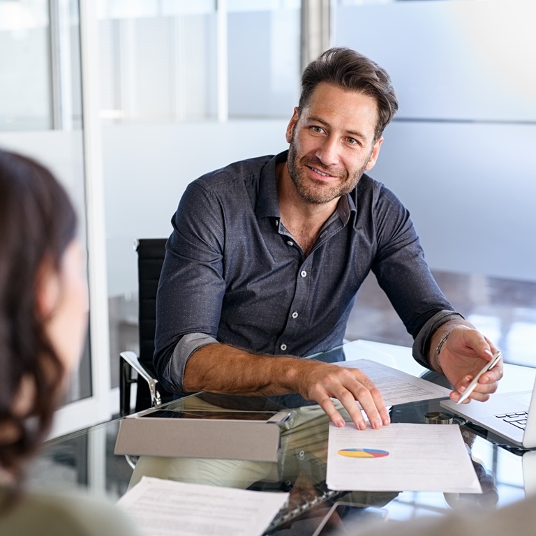 Confident businessman advising couple on finance