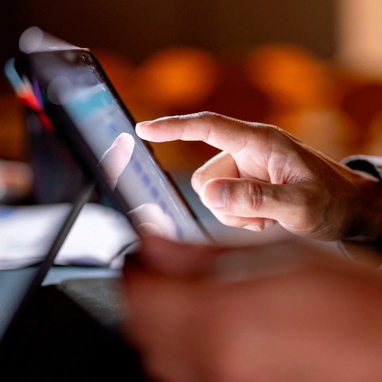 Finger pointing to a tablet