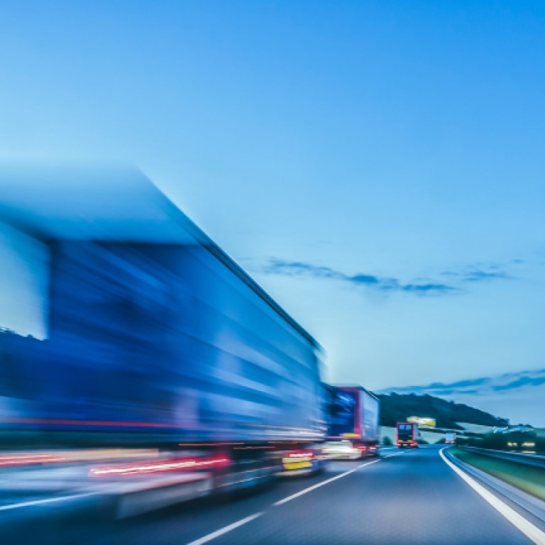 Fleet of commercial vehicles on major road