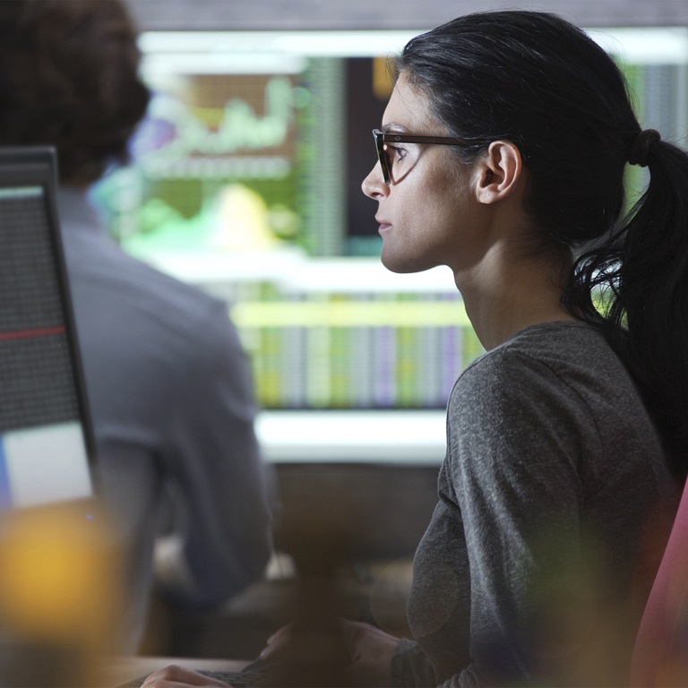 Focused analyst working with data in an office environment