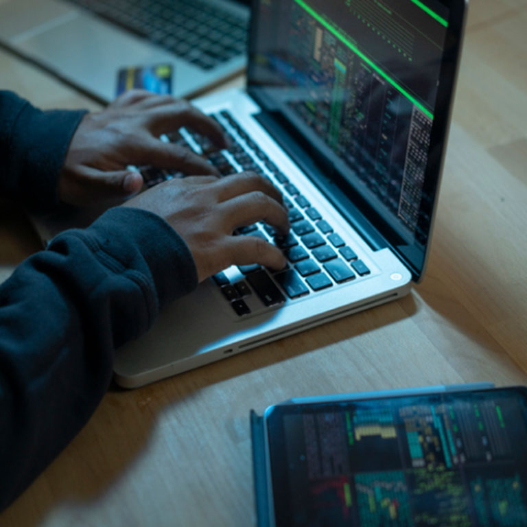 A person coding on a laptop