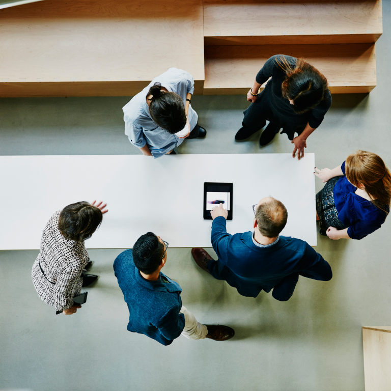 Group of people discussing ideas in a workspace setting