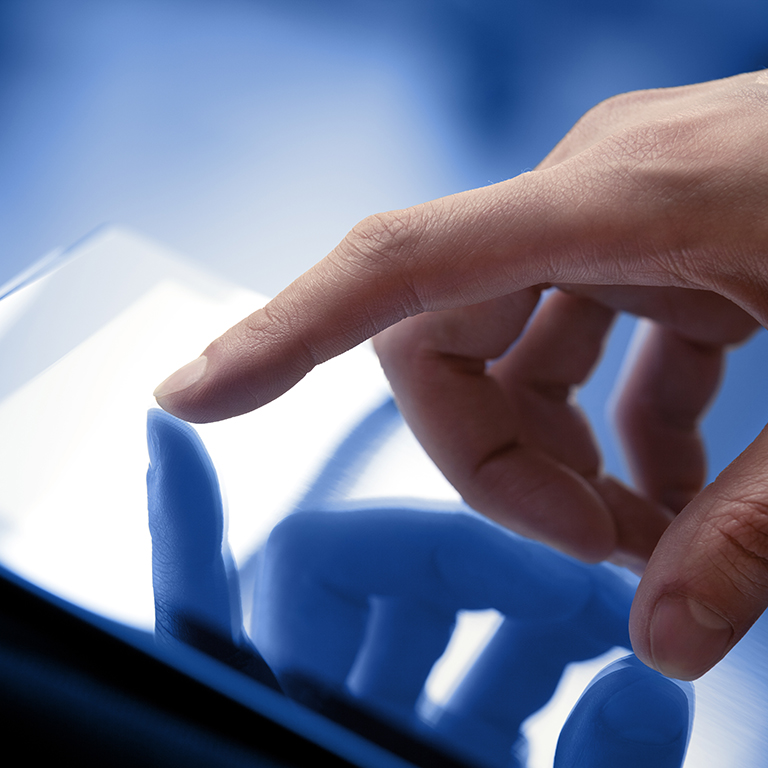 Man hand touching screen on modern digital tablet pc. Close-up image with shallow depth of field focus on finger.