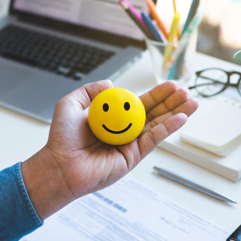 Happy face ball in hand