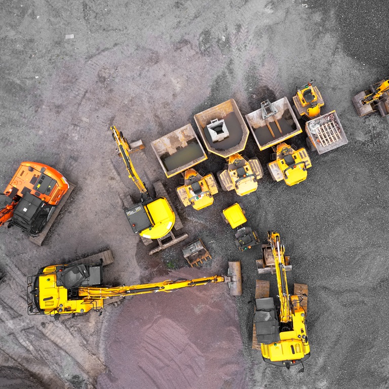 Heavy machinery operating at mining sites from above