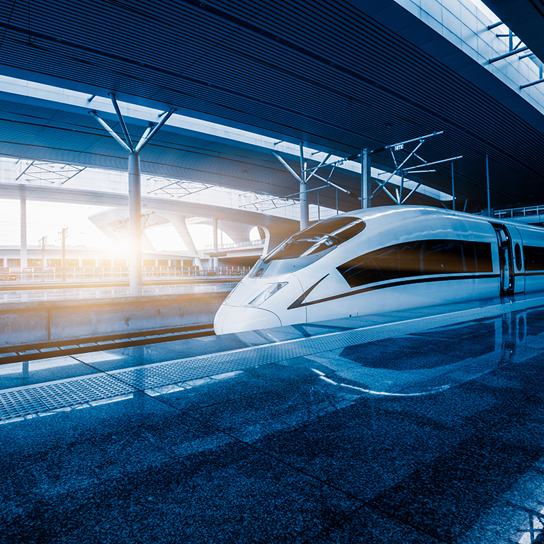 Speeding train away from railway station.