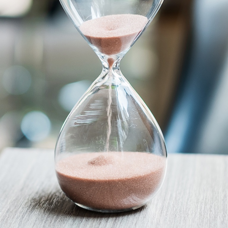 Hourglass on table office with copy space