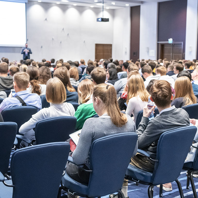 Image of a conference that takes place in a large conference room, workshop for young professionals, training in a large conference room, adult training