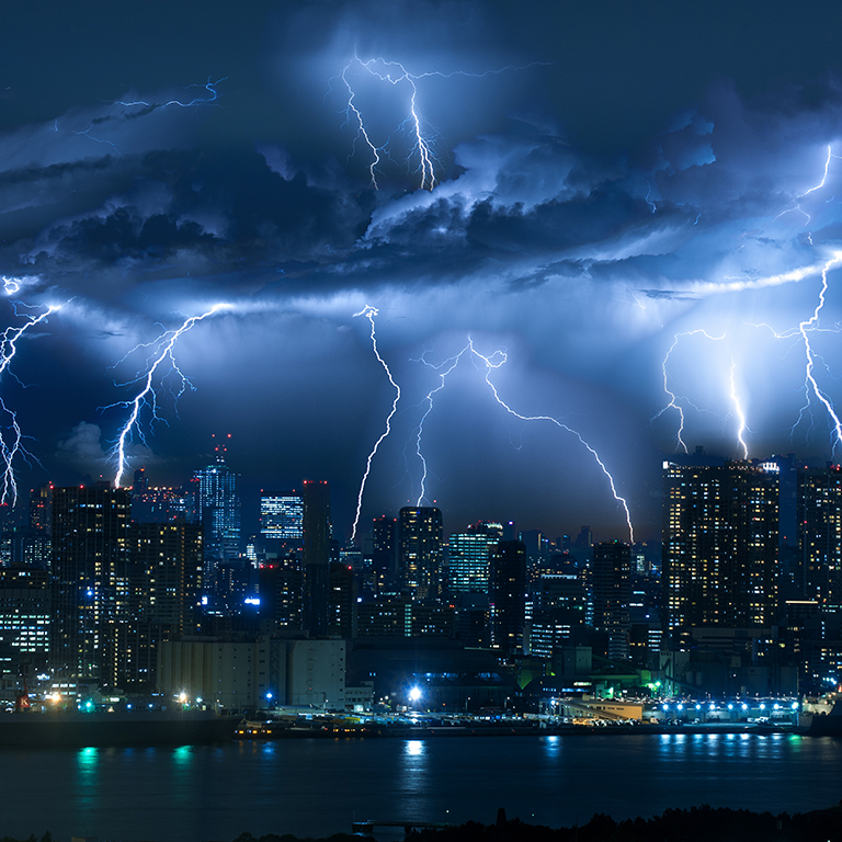 Lightning storm over city in blue light