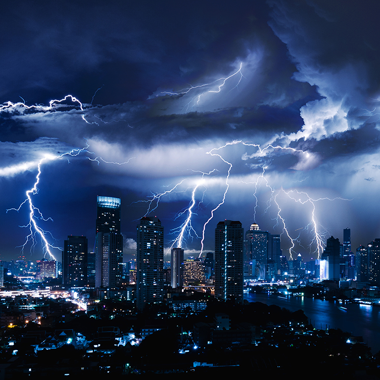 Lightning storm over city in blue light