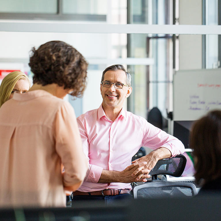 Male and female entrepreneurs discussing strategy during meeting at creative office