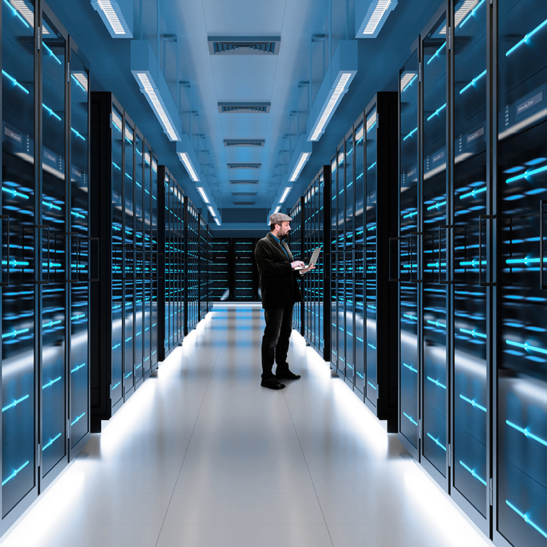 Man checks server racks in data center during work hours