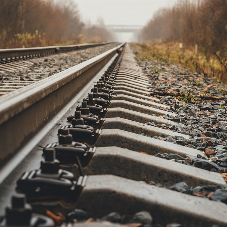 modern railway goes into foggy distance