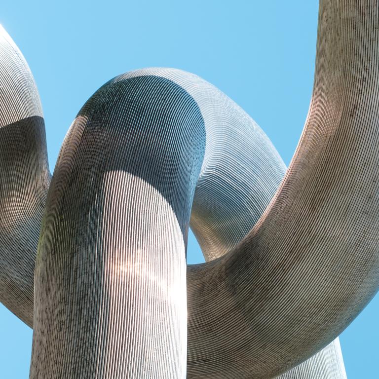 Modern sculpture against blue sky