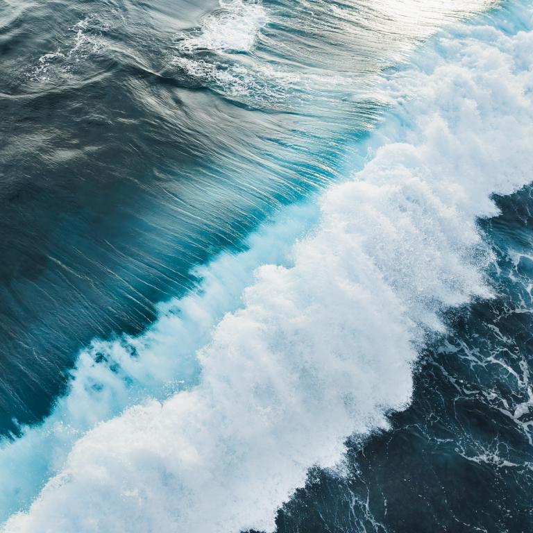 Ocean waves crash against the shore