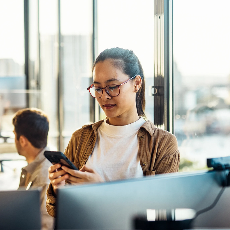 Office woman looking to her phone