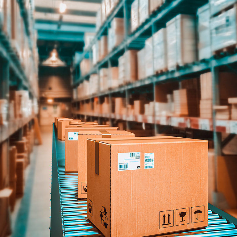 Parcels on conveyor belt in a warehouse. 