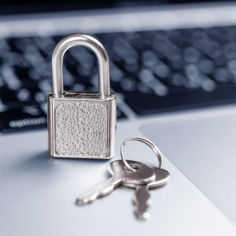 Computer security concept. Padlock on computer keyboard, laptop in office. Cyber security and privacy background 