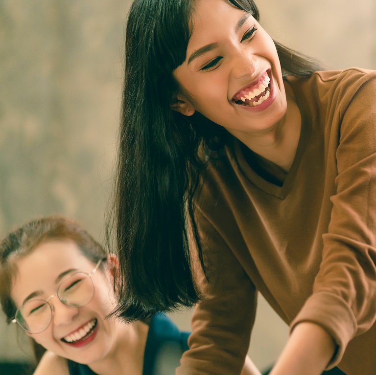 Happy colleagues discussing at office