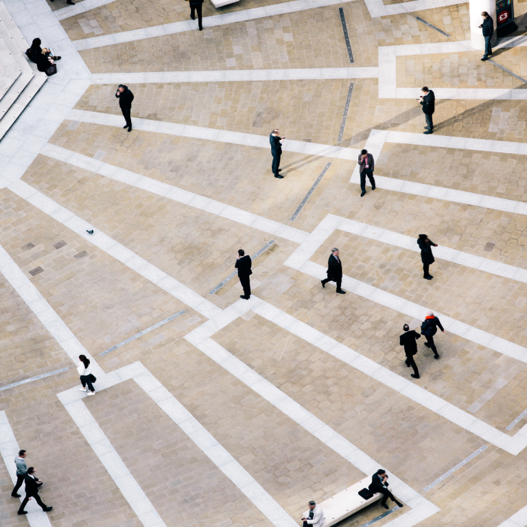 People walking on patterned ground in public space