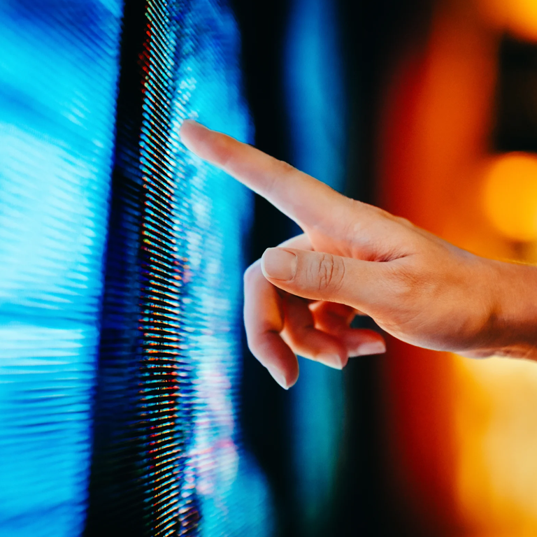 Person interacting with a digital display in a bright space