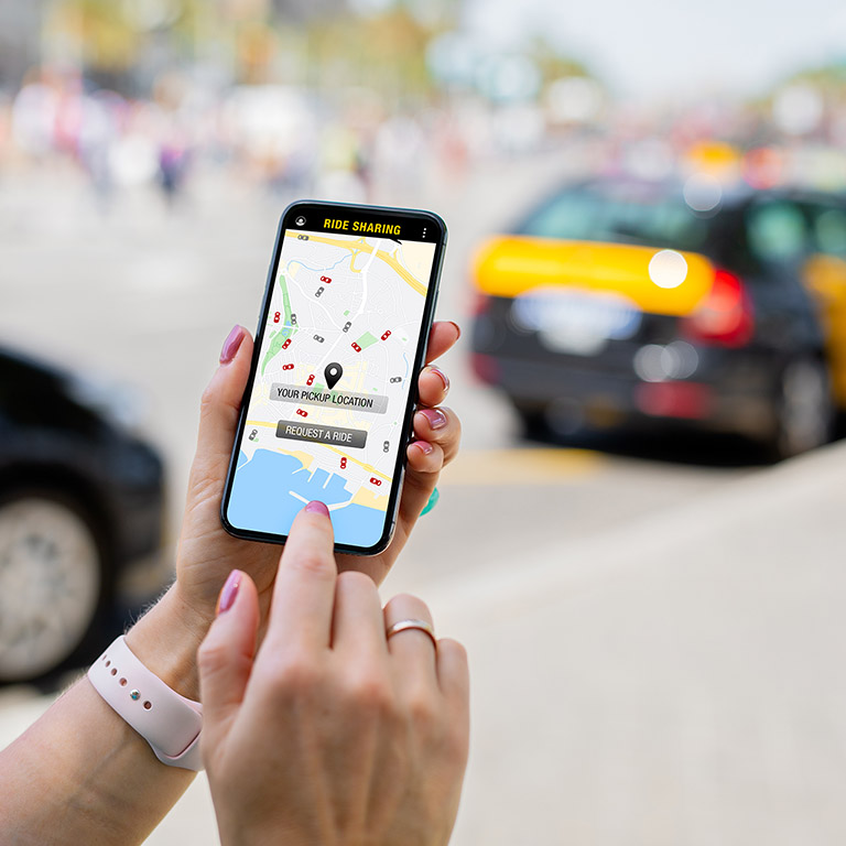 Person using ride sharing app on mobile phone