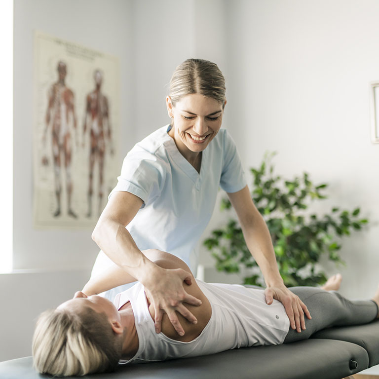 Modern rehabilitation physiotherapy worker with woman client