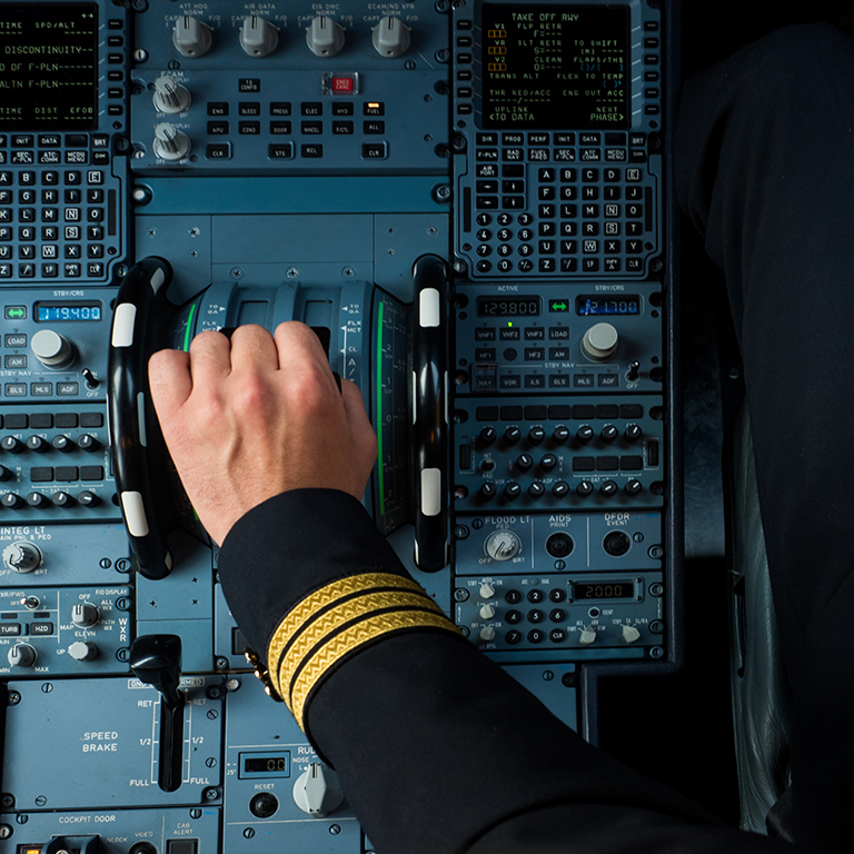 Captain hand accelerating on the throttle in commercial airplane