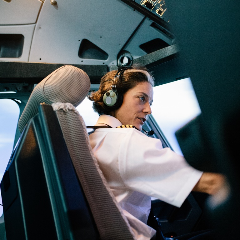 Pilot operates flight simulator in training session