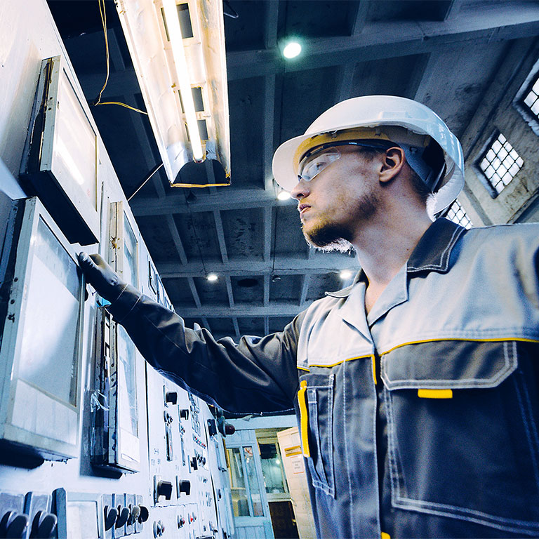 Power plant engineer inspecting machine