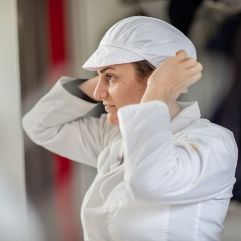 Production worker in white uniform