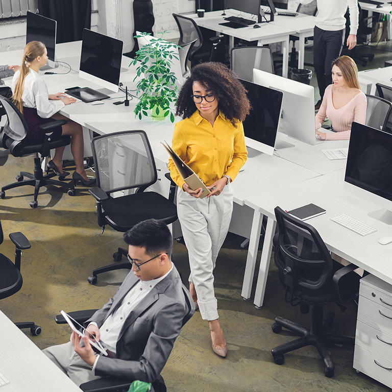 high angle view of professional young business people working with computers and papers in office