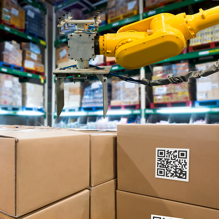 QR Codes Asset warehouse and inventory management supply chain technology concept. Group of boxes and Automation robot arm machine in storehouse.