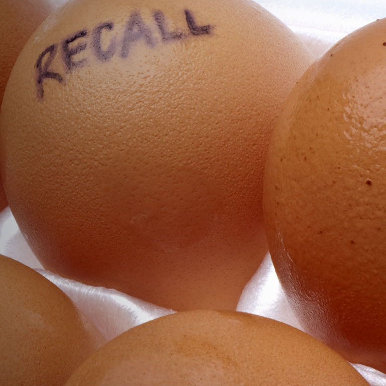 Egg Recall Concept Image with Brown Eggs in a White Carton.