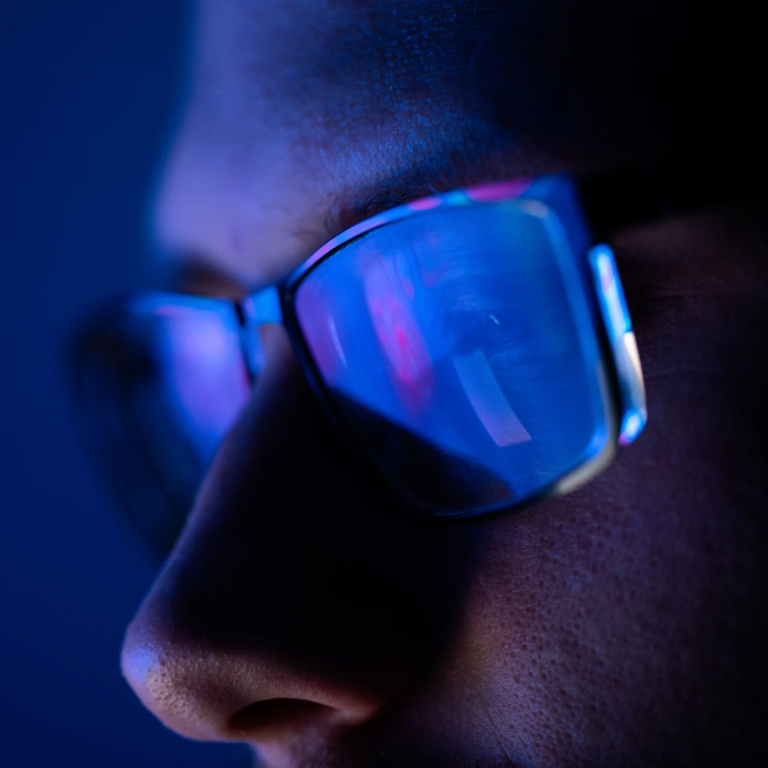 Screens reflecting on a worker's glasses