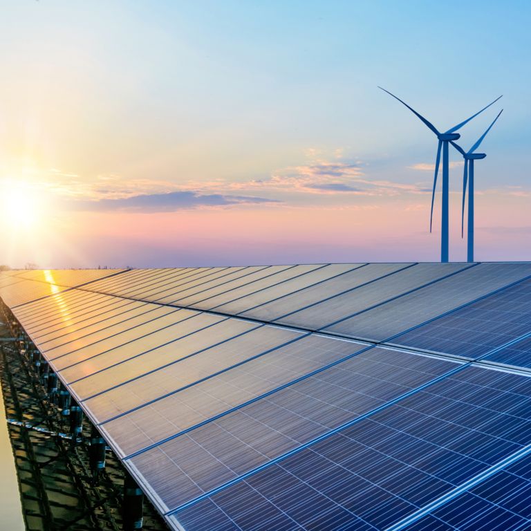 Solar panels and wildmills on the sunset