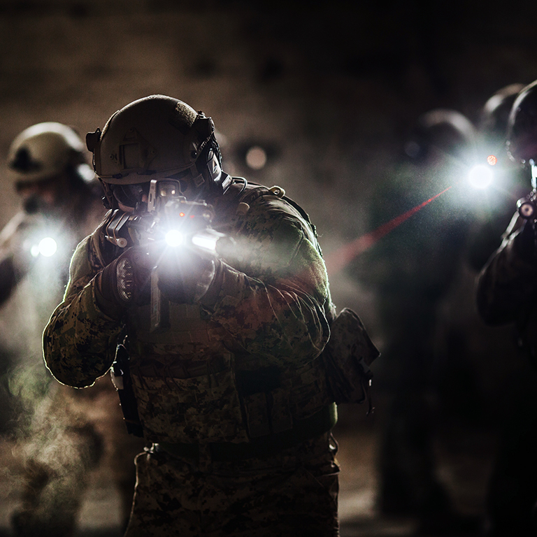 Rangers during the military operation with laser sights and lanterns. Military and police concept.
