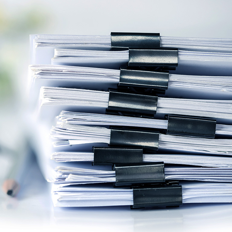 Close up stacked working documents in office
