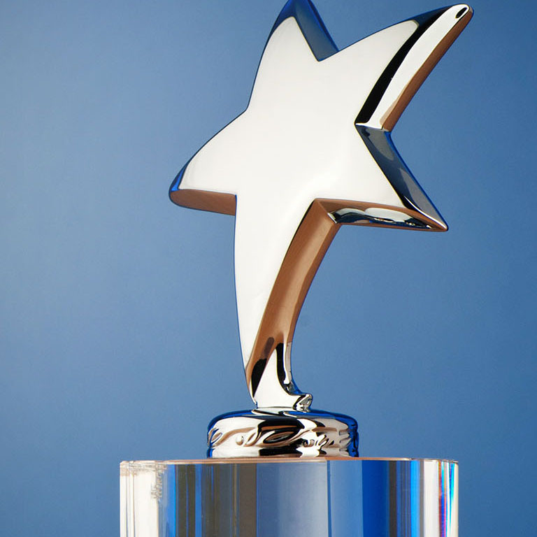 A shiny trophy with a star on top against blue background