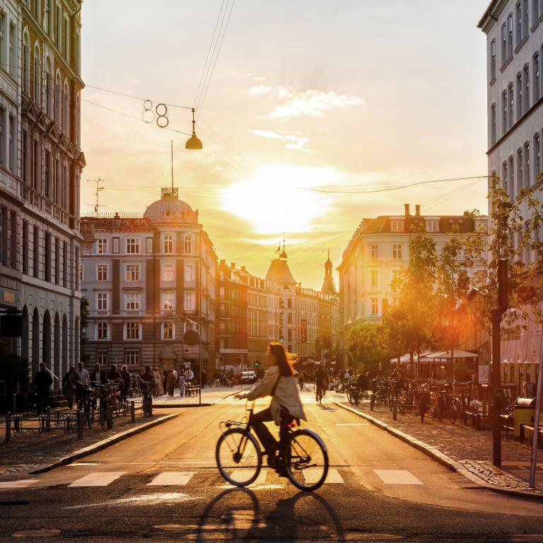 Sunset bike ride on city street in evening light