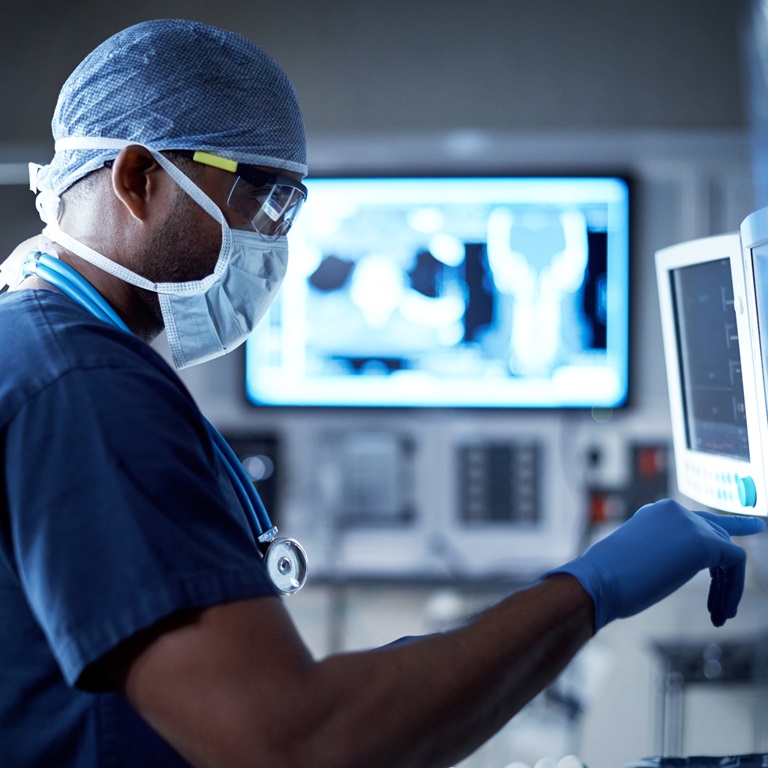 Shot of a surgeon looking at a monitor in an operating room