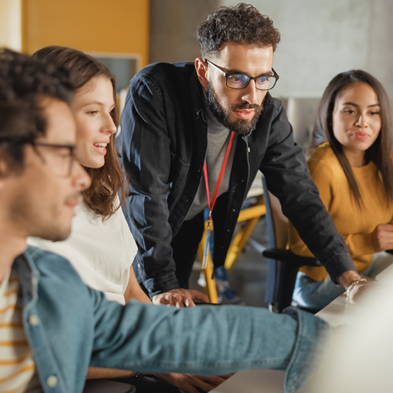 Lecturer Helps Scholar with Project, Advising on Their Work. Teacher Giving Lesson to Diverse Multiethnic Group of Female and Male Students in College