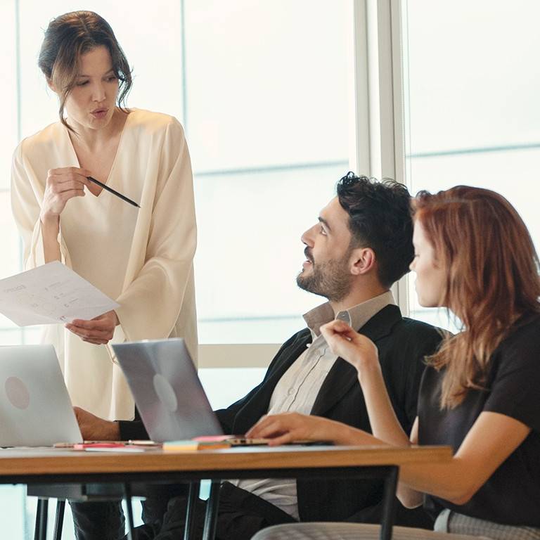Five people meeting and discussing around a table