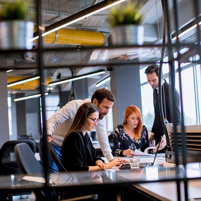 Group of young business people are working together with a laptop in an modern office